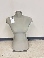 Front view of grey female torso mannequin showing form and fabric surface