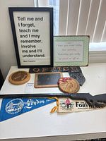 Group shot showing all nine items including framed prints, plaques, signs, pennants and souvenirs
