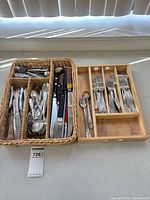 Overview of two trays with flatware, knives, utensils