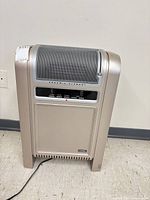 Front view of beige Lasko ceramic space heater showing grille, control panel and power cord