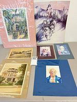 Group shot of all six unframed artworks on tabletop