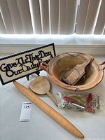 Entire lot showing plaque, bowl with paddles, rolling pin, spatula, bag of can openers
