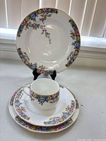 Dinner, dessert plates and cup displayed to show pattern