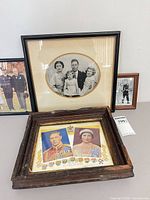 Group of four framed pieces on tabletop