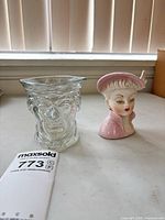 Front view of both head vases showing design and size