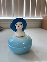 front view showing lady head lid and gradient blue body