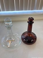Clear and brown glass decanters side by side
