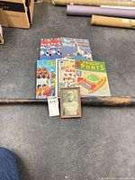 Lot overview: bat, four publications, framed photo