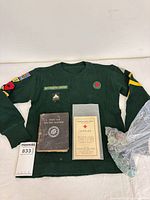 All items together: Boy Scout shirt, two booklets, bag of marbles