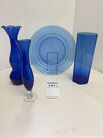 Group shot of three cobalt vases and one light blue plate