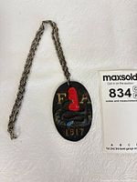 Pendant and full chain laid out showing overall design and size reference