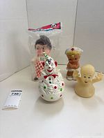 Group shot of all four plastic toys including sealed Big Boy figure, clown wobble toy, nurse with baby, and ghost