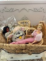 Lot overview showing Barbie, Furby, wicker baskets