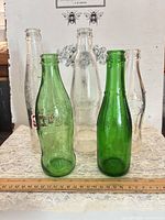 Front view of all five bottles showing size and color differences
