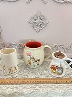 Three ceramic pieces side by side with ruler for scale