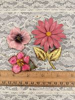 All three floral enamel pins with ruler for scale