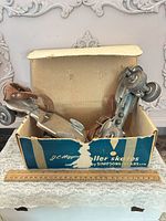 Pair of roller skates in original J.C. Higgins box with ruler for scale