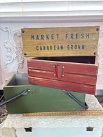 All three wooden crates stacked showing colors and stencil text