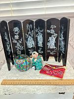 Front view of all four items including six-panel screen, bowl, figurine, pouch