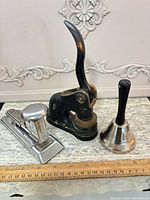 embosser, stapler, bell with ruler for scale