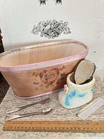Group shot showing wooden box, ceramic boot jar, spoons, comb and hairbrush
