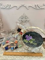 Group shot of basket, spools bagged, ruler for scale