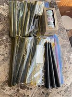 Bags of taper candles and boxed Trader Joe's candle trio on tabletop