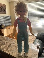 Full view of 33-inch doll standing on countertop