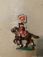 Left side view of painted lead cavalry soldier on horseback with flag