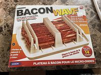 Front of boxed Emson Bacon Wave showing product image and details