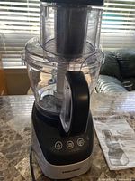 Front view showing food processor assembly and manual