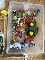 Overview of bin with mixed toys and figures