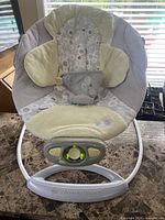 Front view of Bright Starts Automatic Bouncer showing seat fabric, frame, and control module