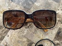 Front view of brown tortoise Coach sunglasses with gradient lenses