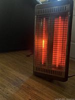 Heater powered on showing glowing quartz elements and front grille