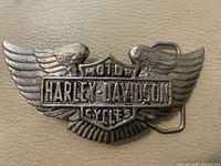 Front of winged Harley-Davidson belt buckle showing logo and design details