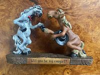 Front view of entire figurine showing both horses and inscription