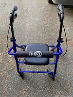 Front view of blue Hugo rollator showing seat, backrest, hand brakes and wheels