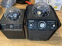 Front view showing two ION speakers with LED domes and control panel