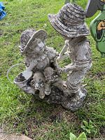 Front view of resin boy and girl planter statue