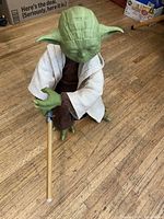 Full view of Yoda figure kneeling with lightsaber