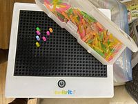 Full view of Lite-Brite board with peg case and pegs inserted