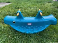 Front view of blue whale rocker showing logo and overall shape