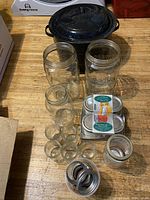 Overview showing enamel canning pot, assorted Mason jars, new lid pack and loose rings