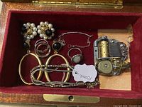 Interior view showing jewelry pieces and movement