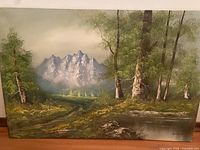 Front view of entire oil painting showing mountain landscape