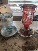 Front view of both glass hummingbird feeders on countertop