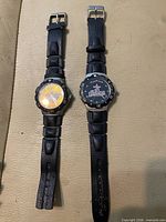 Front view of both watches showing dials, bezels, straps