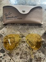 Sunglasses folded with case showing Ray-Ban AmberMatic marking