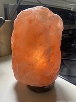 Front view of illuminated salt lamp showing crystal texture and glow